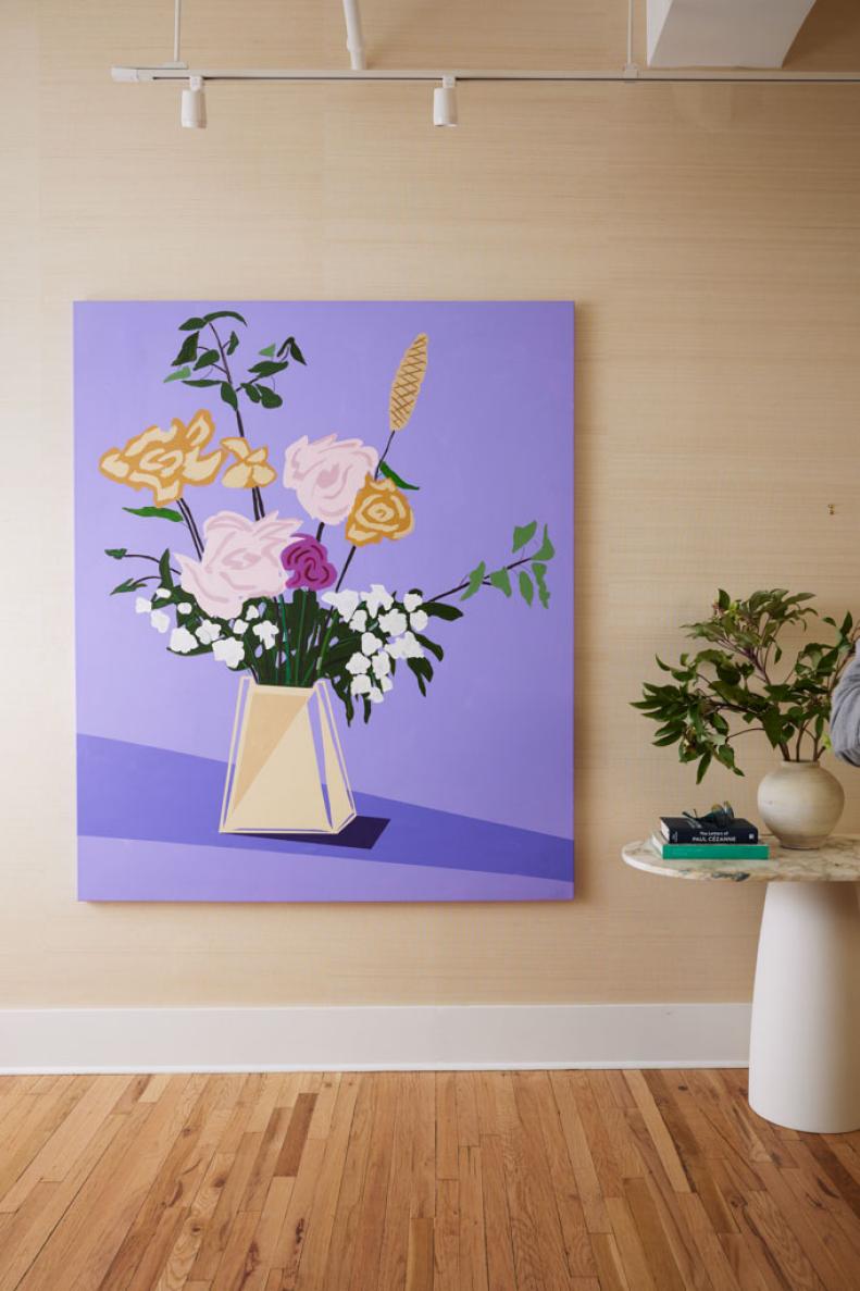 A photo of a purple floral painting in the entryway.